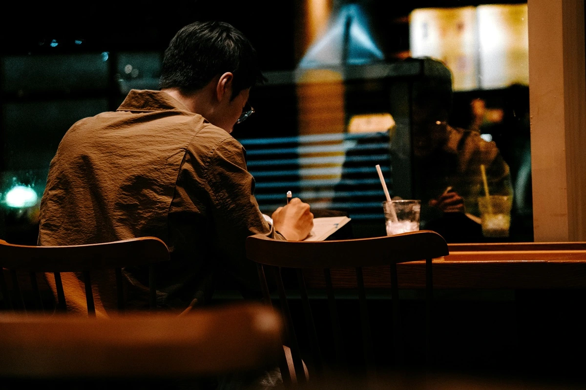 Person Writing Alone at Night