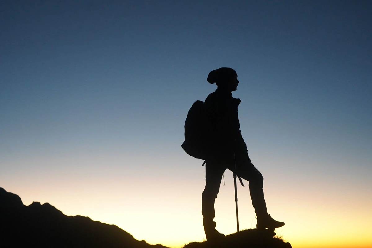 man hiking sunrise