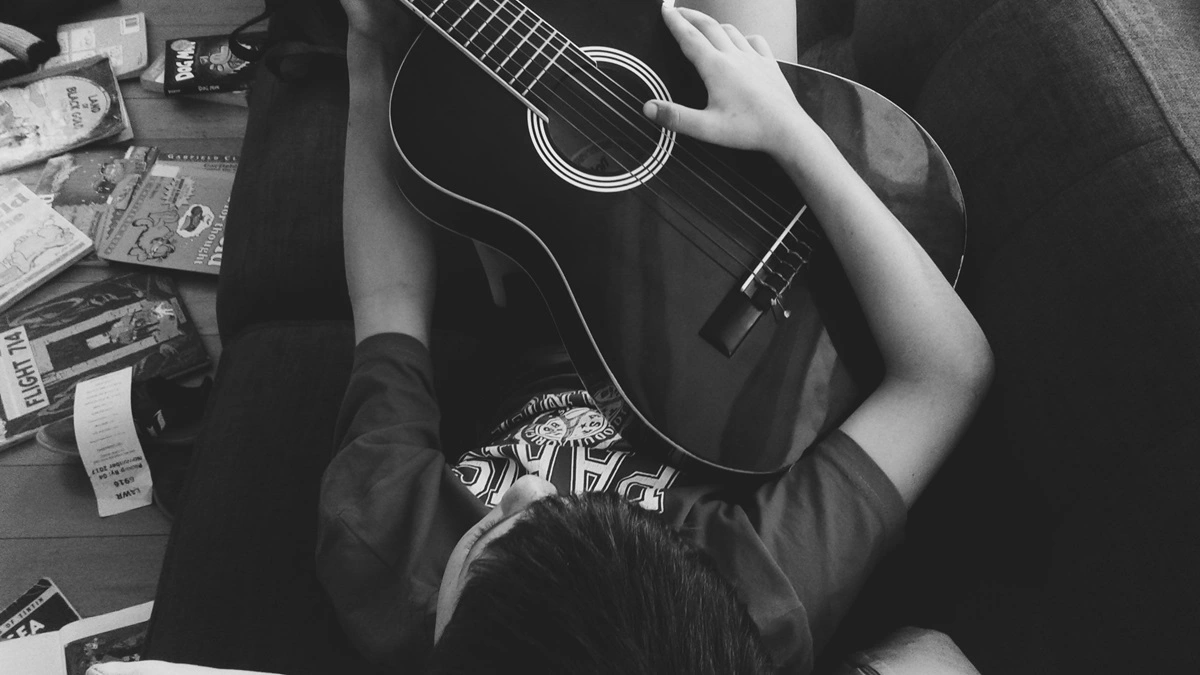 Person Playing Guitar Alone